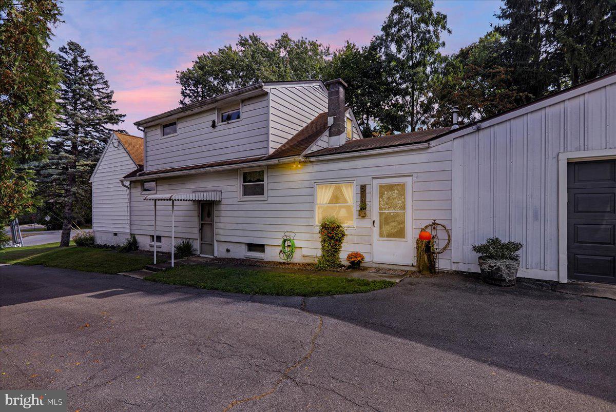 518 Spring Valley Road Reading, PA 19604 - Photo 1 of 49 a front view of a house with a yard and garage