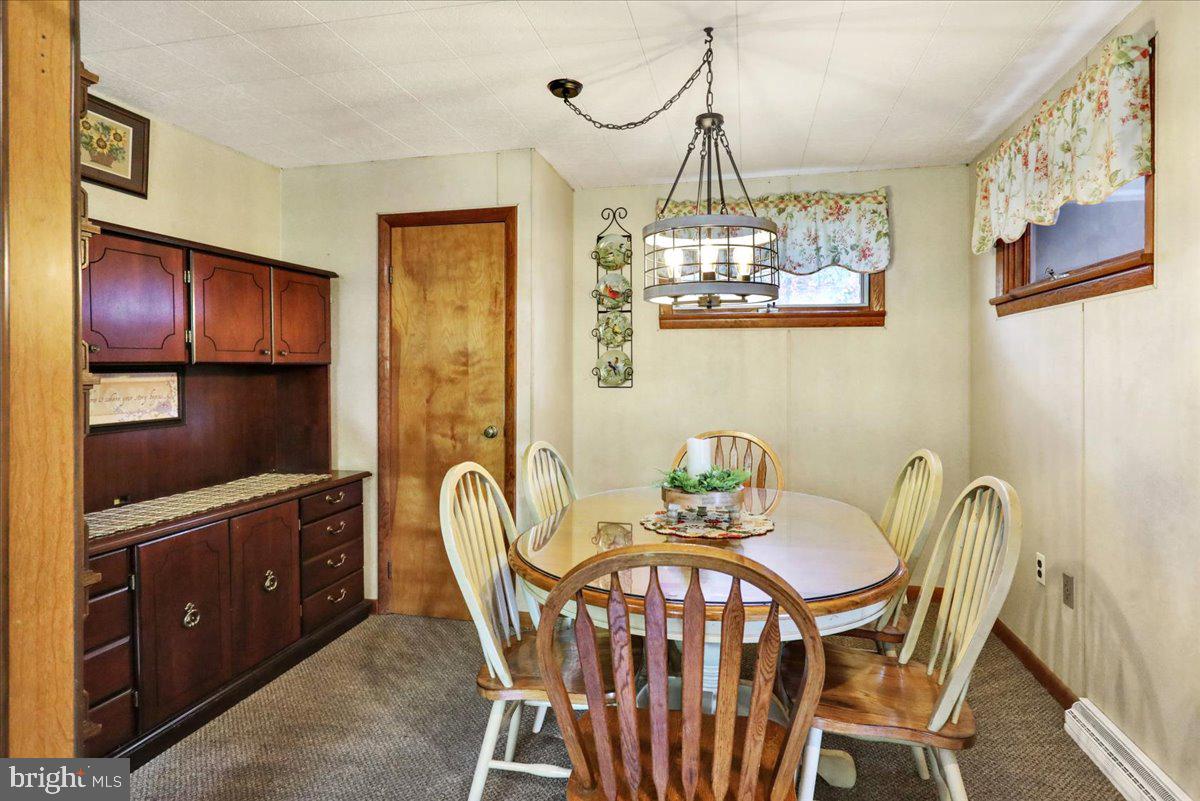 518 Spring Valley Road Reading, PA 19604 - Photo 12 of 49 a view of a dining room with furniture a chandelier and wooden floor
