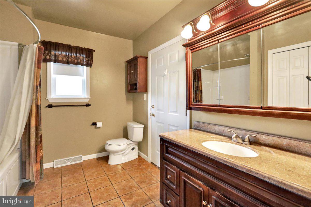 518 Spring Valley Road Reading, PA 19604 - Photo 20 of 49 a bathroom with a granite countertop sink and a mirror