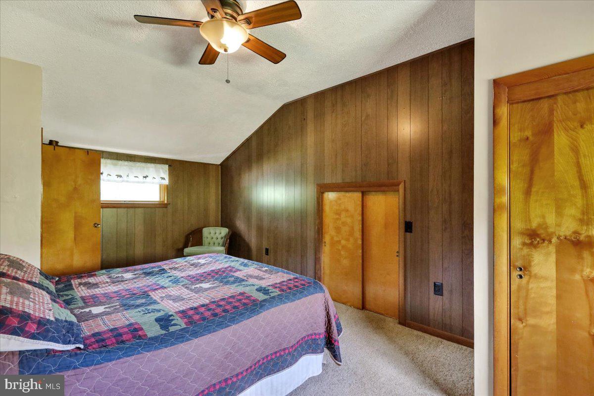 518 Spring Valley Road Reading, PA 19604 - Photo 26 of 49 a bedroom with a bed and a chandelier