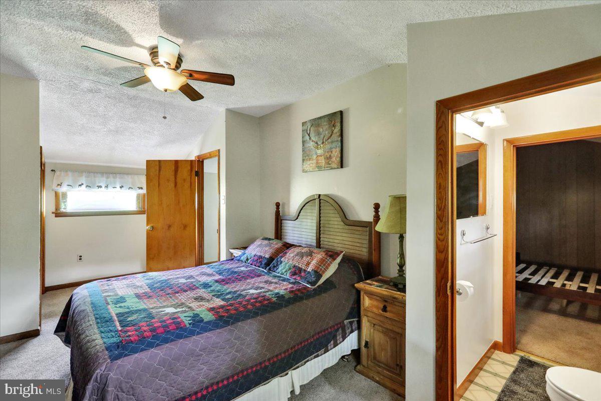 518 Spring Valley Road Reading, PA 19604 - Photo 27 of 49 a bedroom with a bed and a chandelier