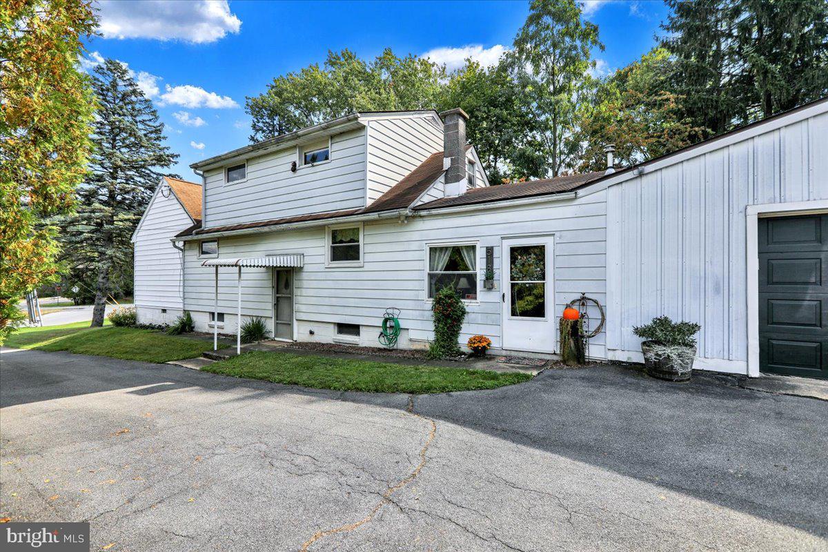 518 Spring Valley Road Reading, PA 19604 - Photo 3 of 49 a front view of a house with a yard and garage