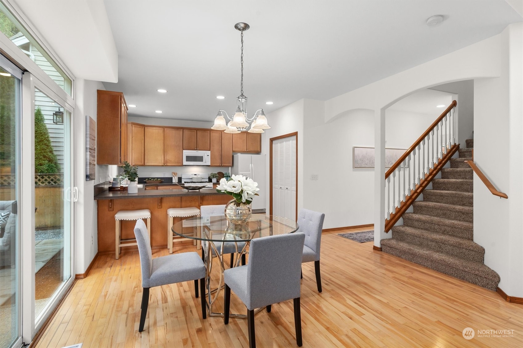 18705 13th Drive Southeast Bothell, WA 98012 - Photo 11 of 40 a view of a dining room and livingroom with furniture wooden floor a chandelier