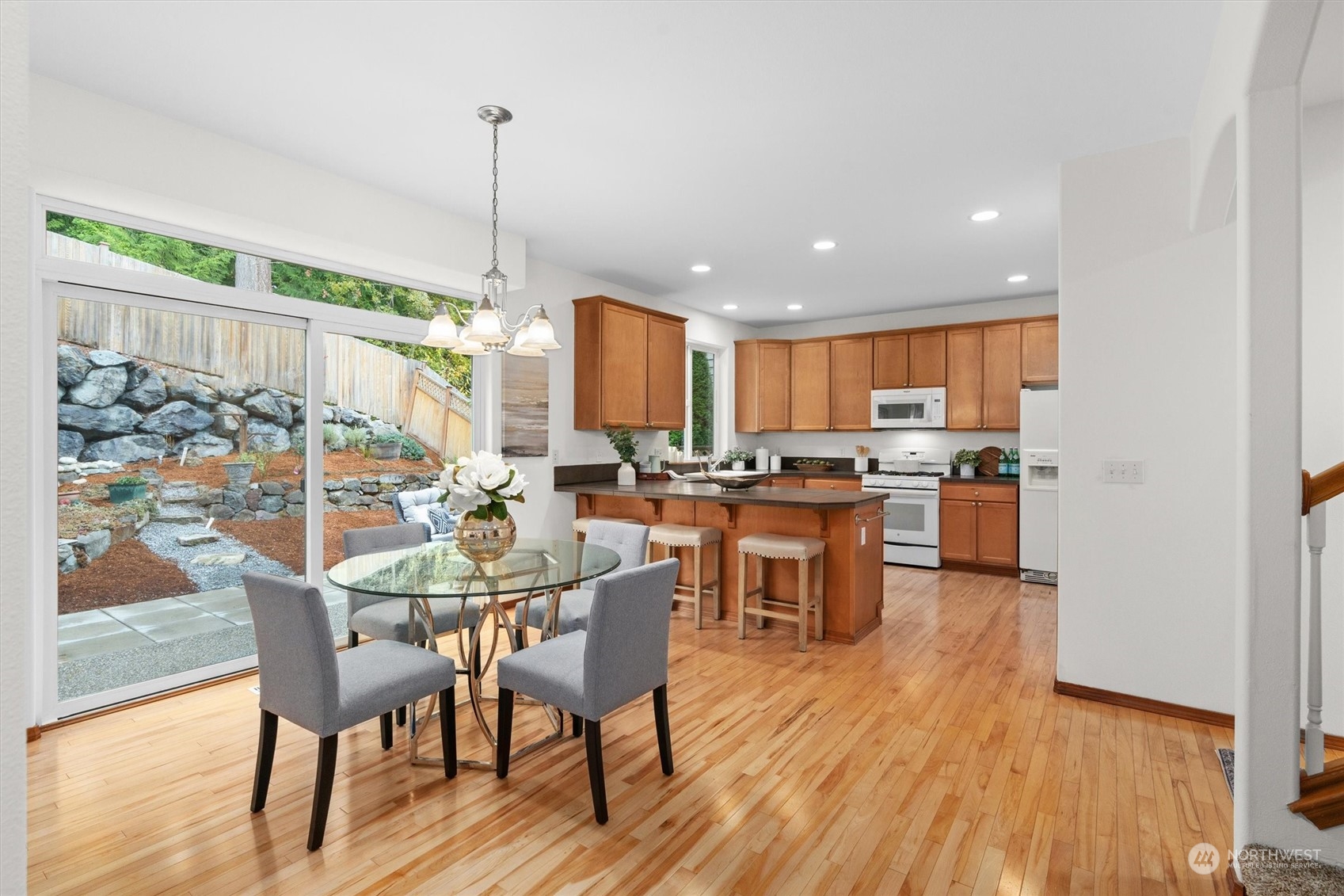 18705 13th Drive Southeast Bothell, WA 98012 - Photo 12 of 40 a view of a dining room and livingroom with furniture wooden floor a chandelier