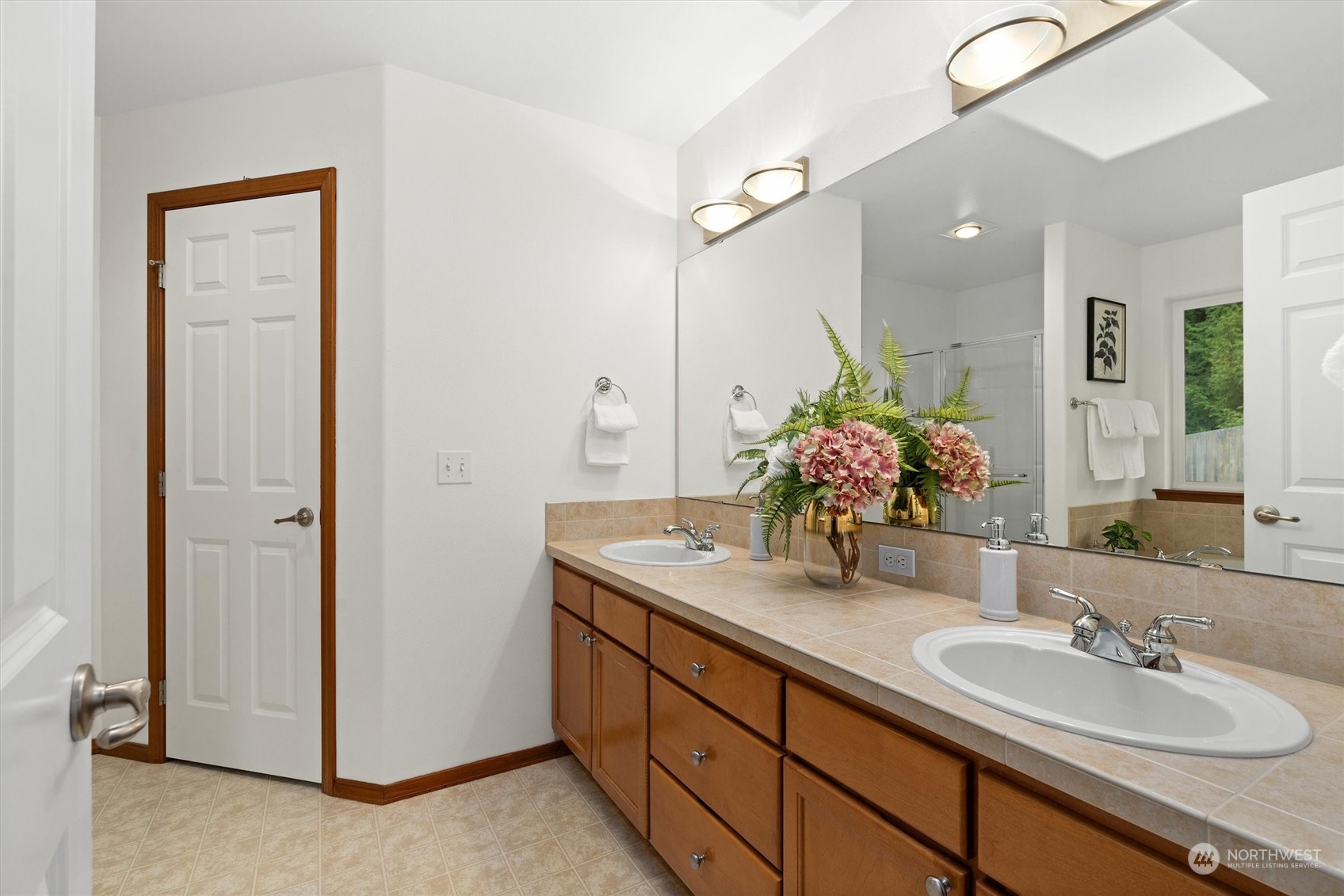 18705 13th Drive Southeast Bothell, WA 98012 - Photo 22 of 40 a bathroom with a double vanity sink and a mirror