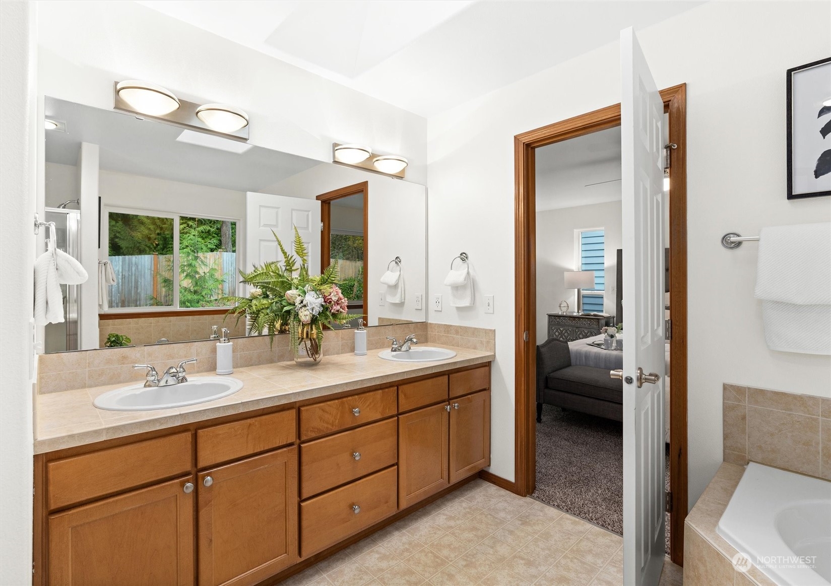 18705 13th Drive Southeast Bothell, WA 98012 - Photo 24 of 40 a en suite bathroom with a double vanity sink a mirror and a shower