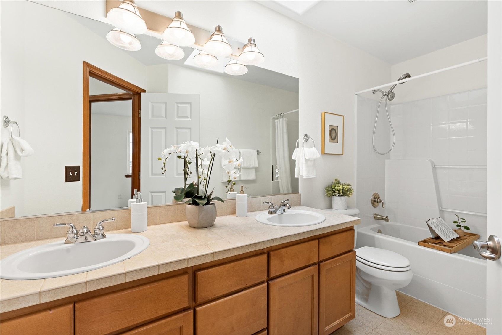 18705 13th Drive Southeast Bothell, WA 98012 - Photo 28 of 40 a bathroom with a double vanity sink and a mirror