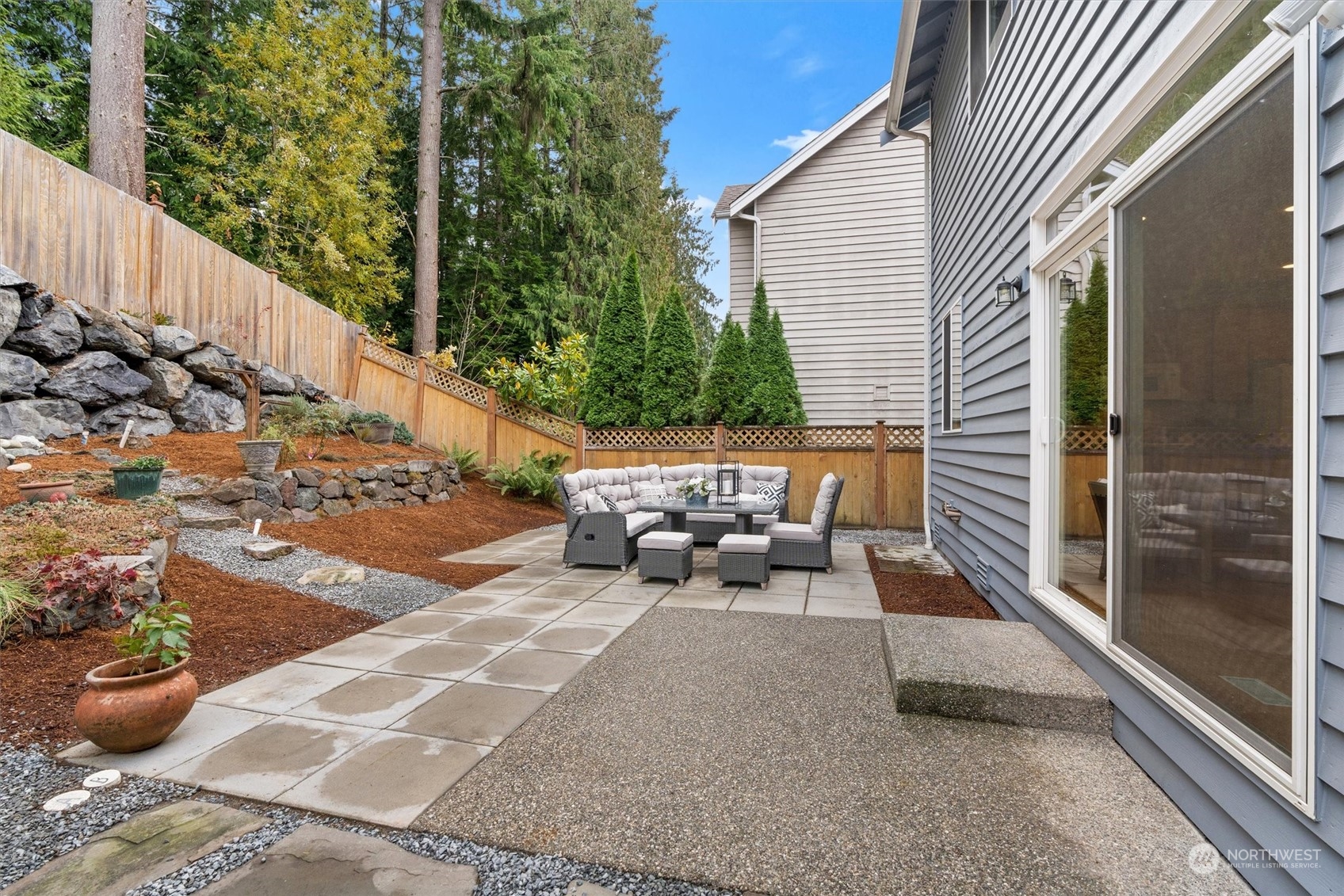 18705 13th Drive Southeast Bothell, WA 98012 - Photo 31 of 40 a view of a patio with table and chairs and potted plants