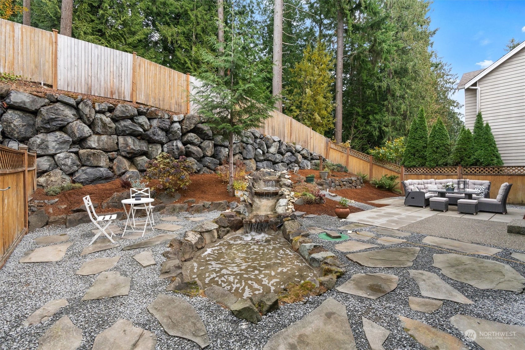 18705 13th Drive Southeast Bothell, WA 98012 - Photo 33 of 40 a view of a backyard with lawn chairs and iron fence