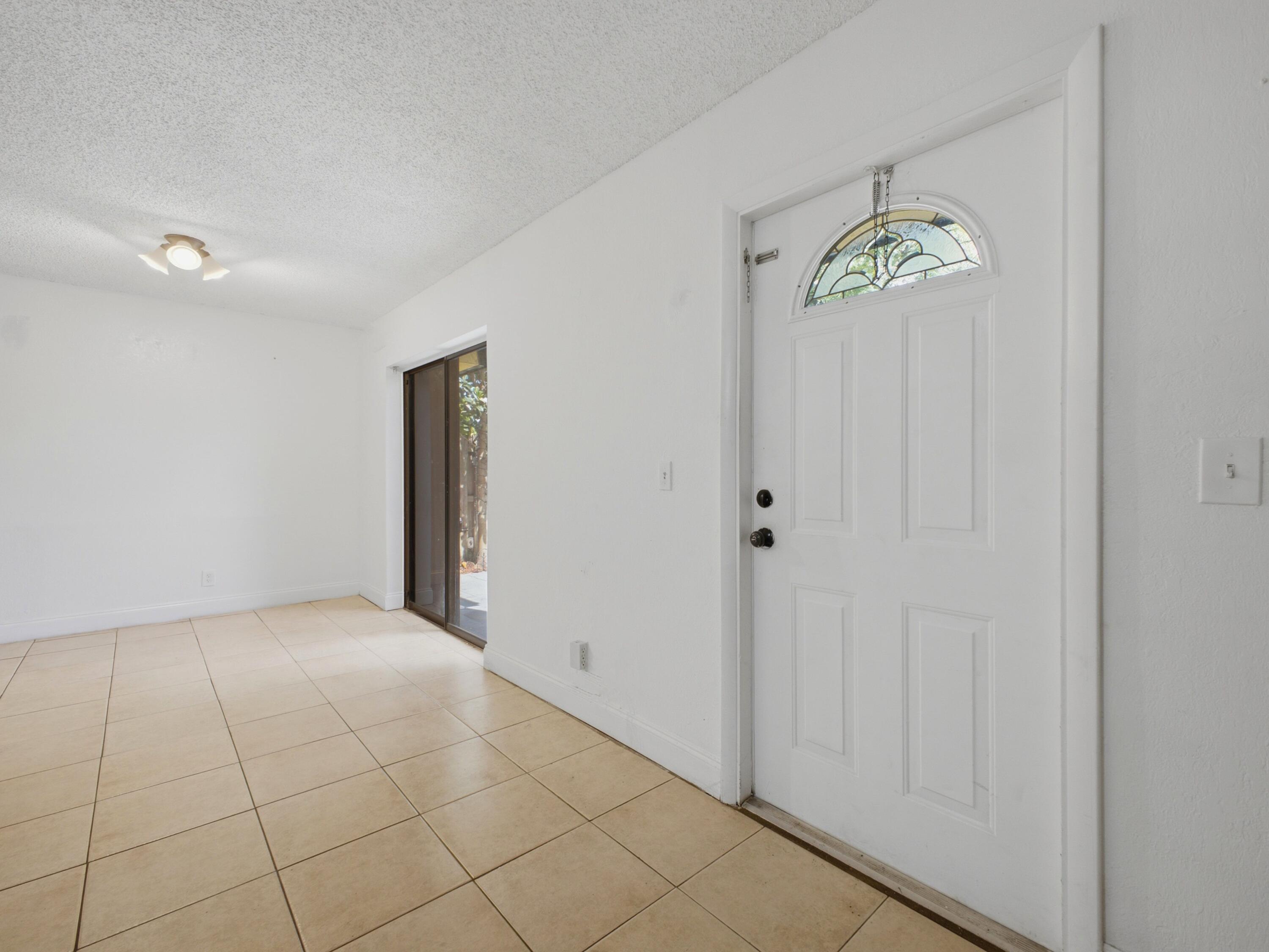 105 Woodland Road Palm Springs, FL 33461 - Photo 7 of 44 Foyer to Dining