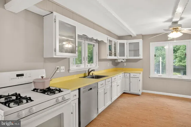 a kitchen with a sink stove and window