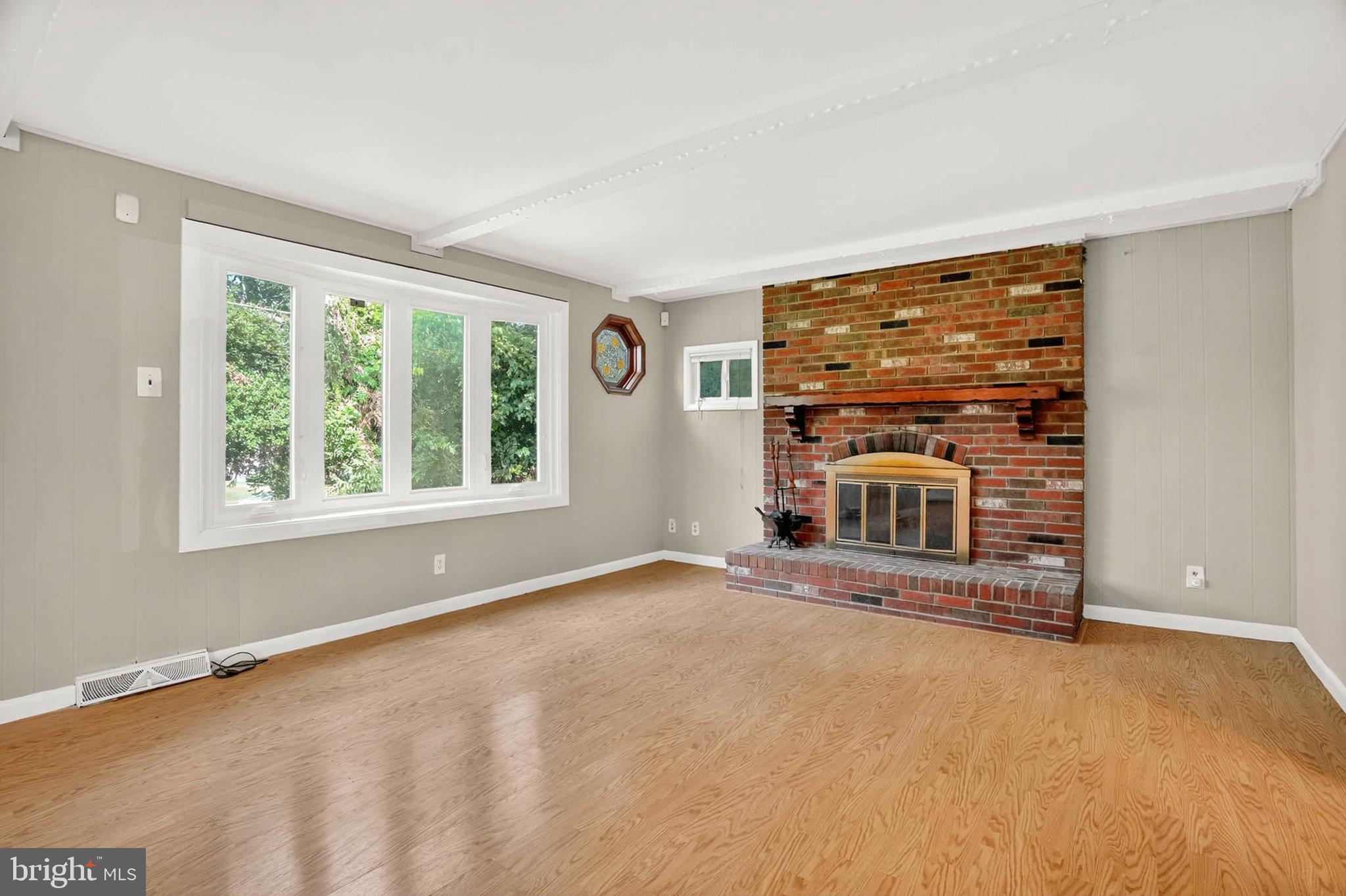 2504 Edgewood Avenue Parkville, MD 21234 - Photo 13 of 25 a view of an empty room with a fireplace and a window