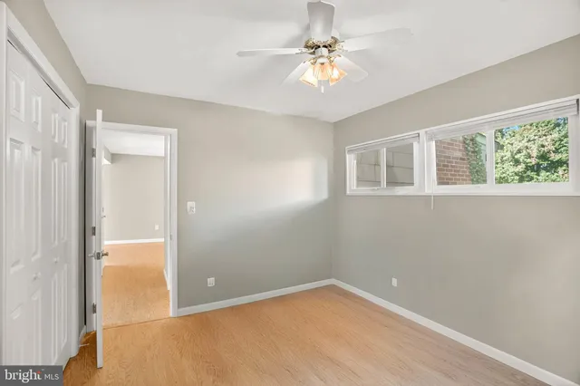 a view of room with window and ceiling fan