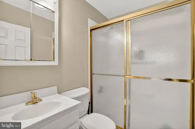 a view of an empty room and chandelier fan