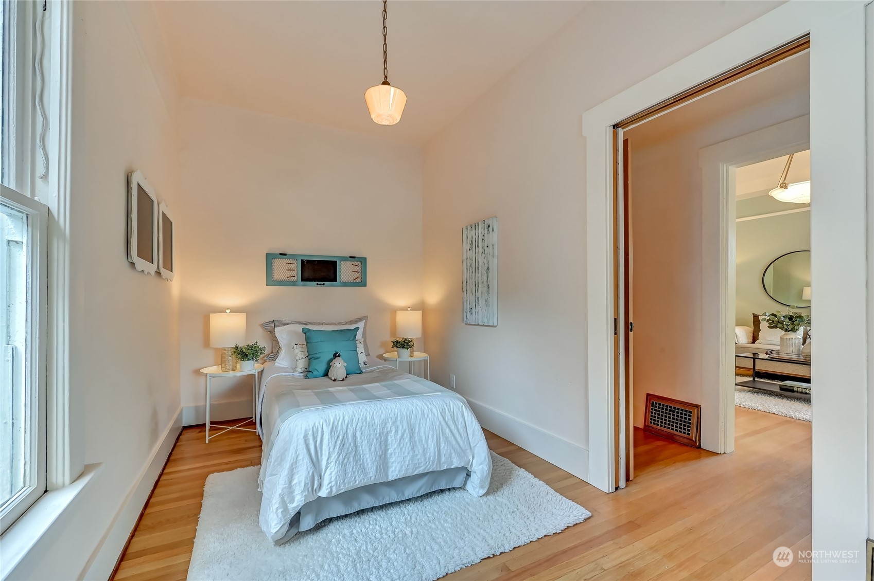 424 North 67th Street Seattle, WA 98103 - Photo 14 of 28 a bedroom with a bed and wooden floor