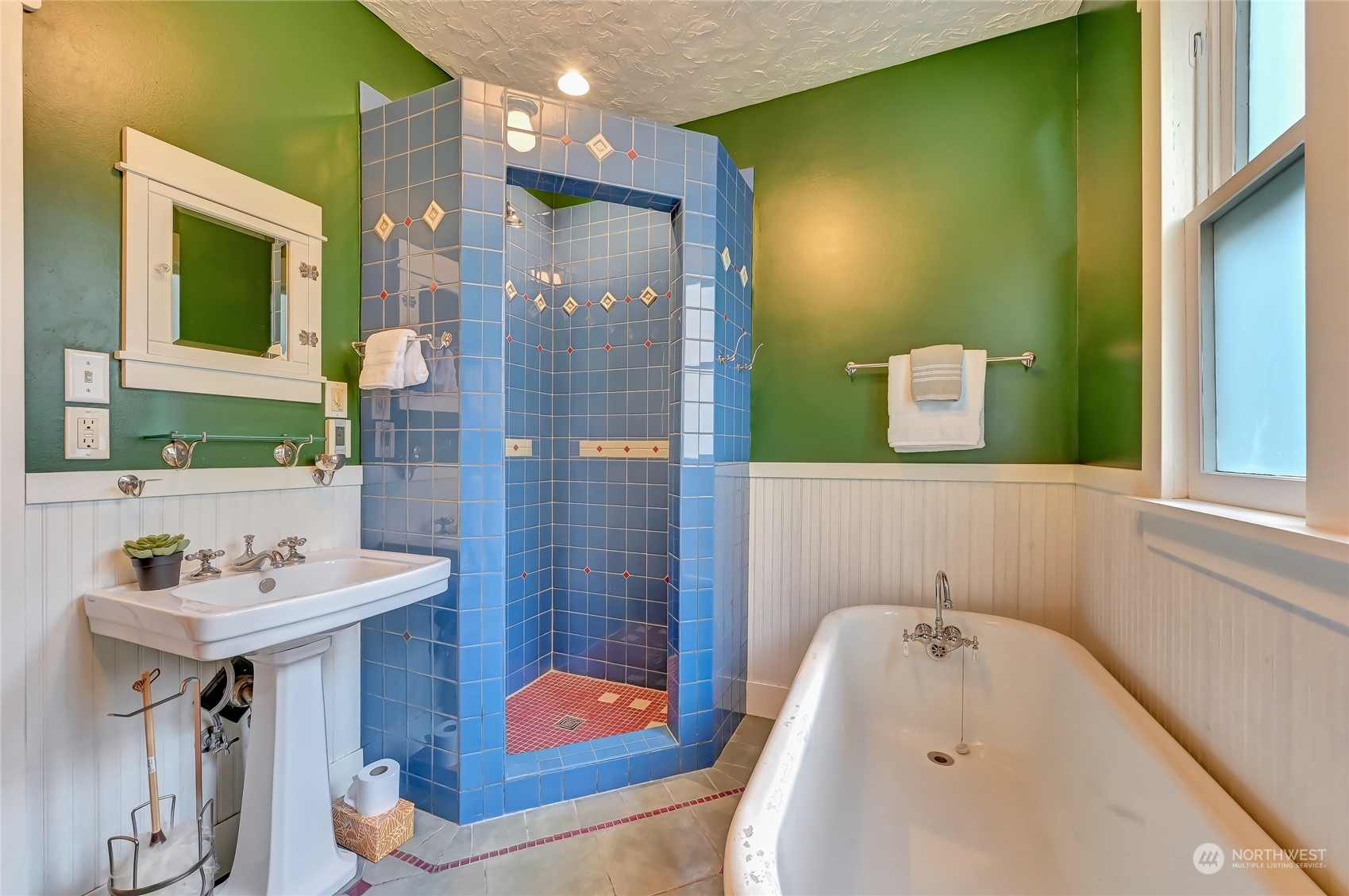 424 North 67th Street Seattle, WA 98103 - Photo 16 of 28 a bathroom with a sink mirror and tub