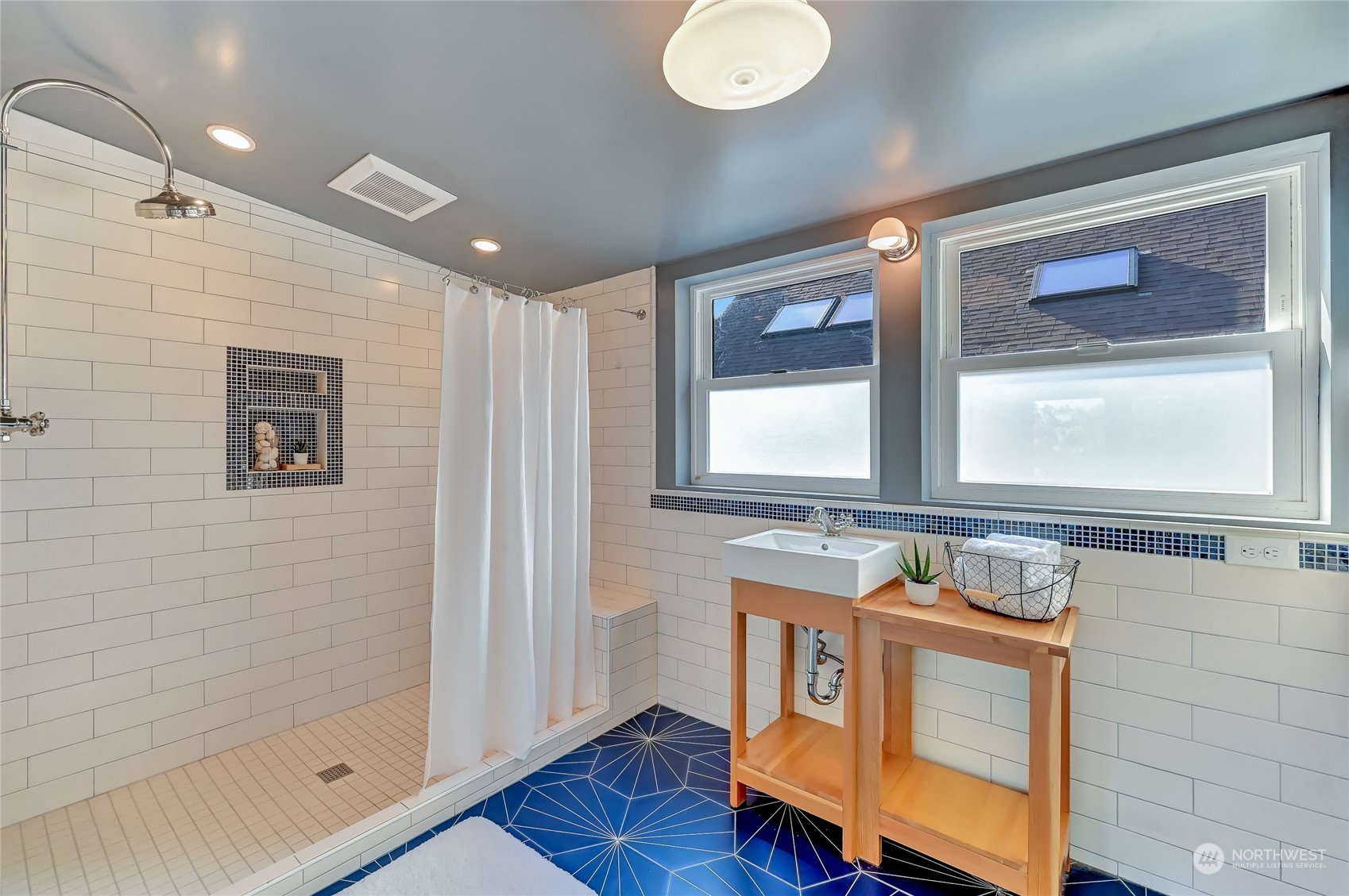 424 North 67th Street Seattle, WA 98103 - Photo 23 of 28 a bathroom with a sink mirror vanity and toilet