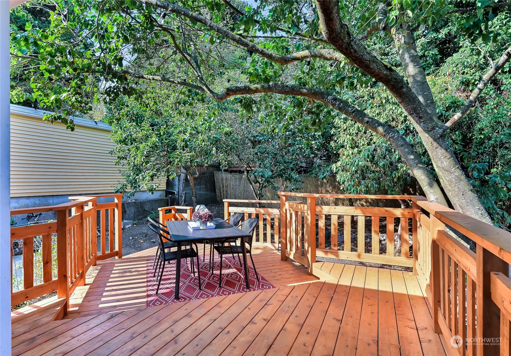 424 North 67th Street Seattle, WA 98103 - Photo 5 of 28 a balcony with wooden floor table and chairs