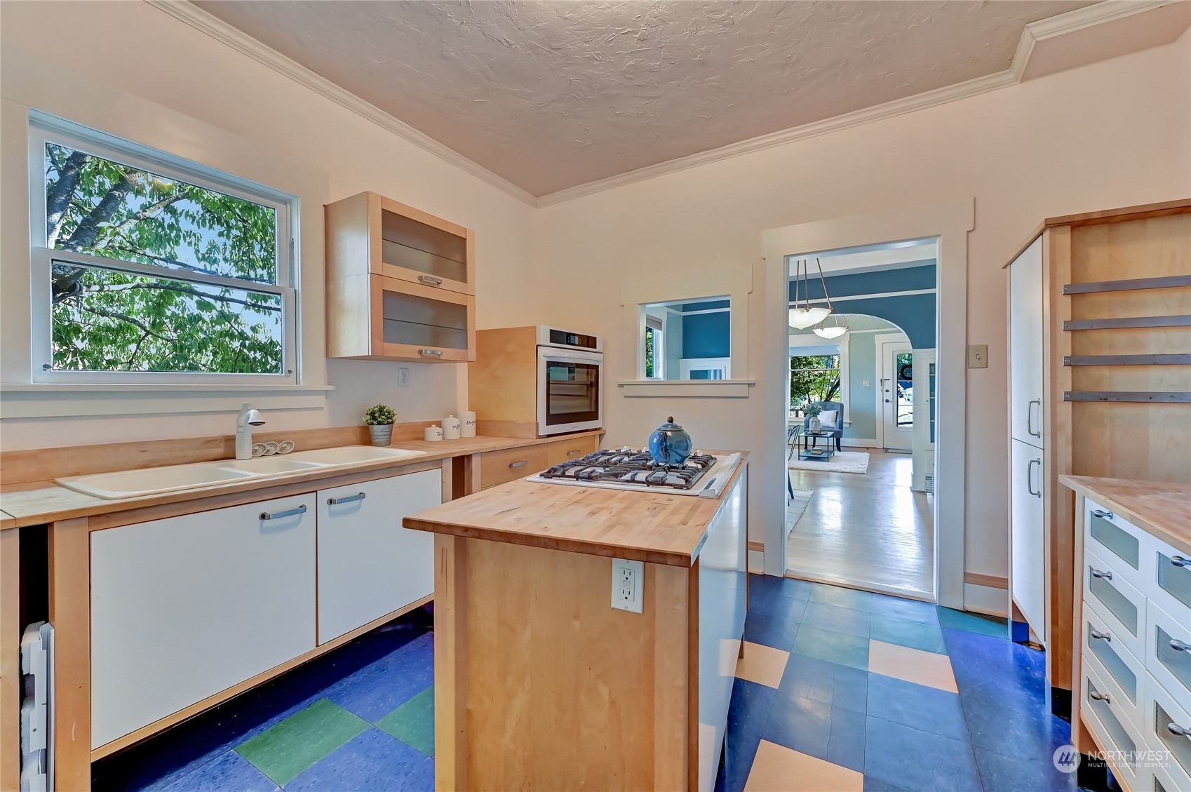 424 North 67th Street Seattle, WA 98103 - Photo 6 of 28 a kitchen with sink cabinets and wooden floor