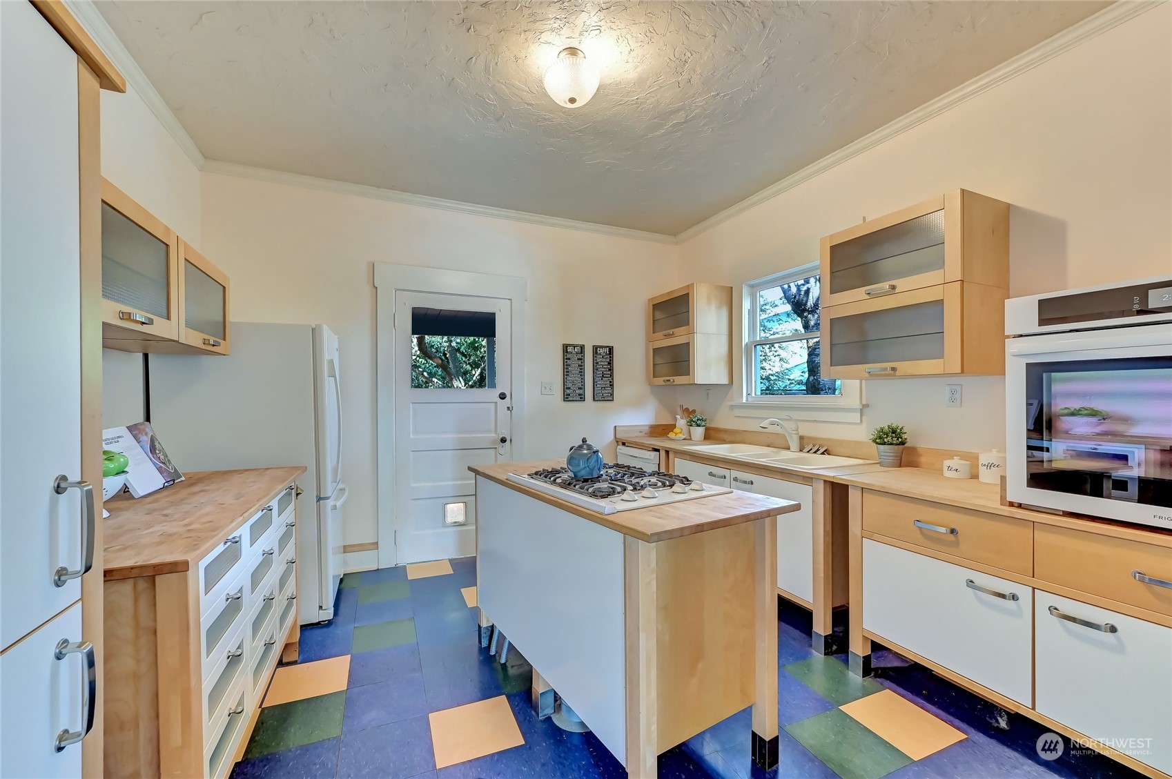 424 North 67th Street Seattle, WA 98103 - Photo 7 of 28 a kitchen that has a sink a stove and wooden floor
