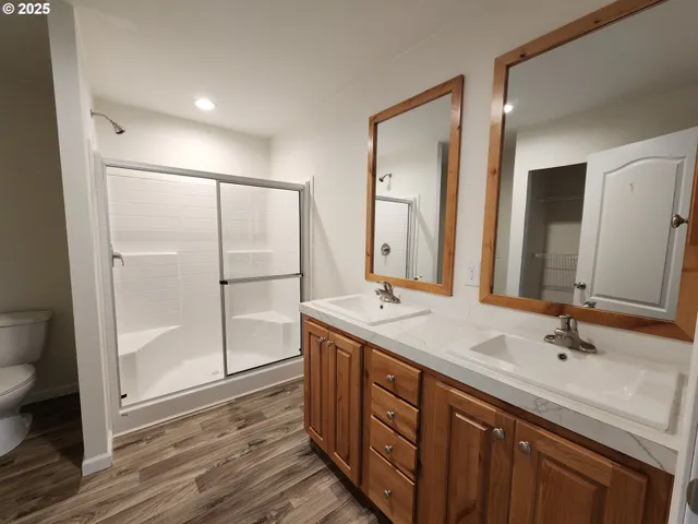 a bathroom with a double vanity sink mirror and shower