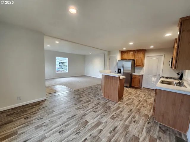 a kitchen with stainless steel appliances granite countertop a refrigerator sink and cabinets