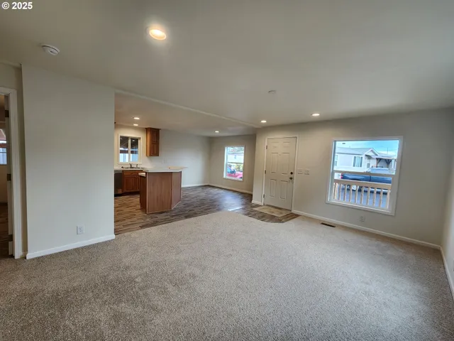 an empty room with a empty space and windows