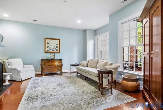 a open kitchen with white cabinets and wooden floor