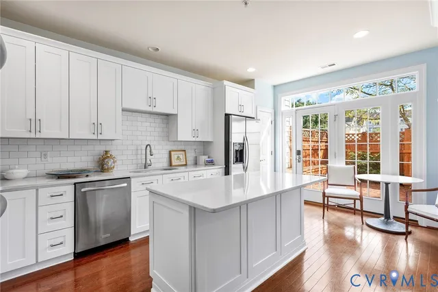 a kitchen with cabinets stainless steel appliances and a counter space
