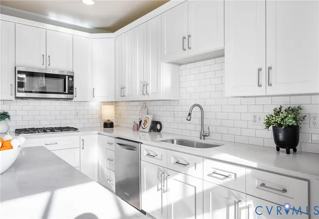 a living room with furniture a wooden floor and a large window