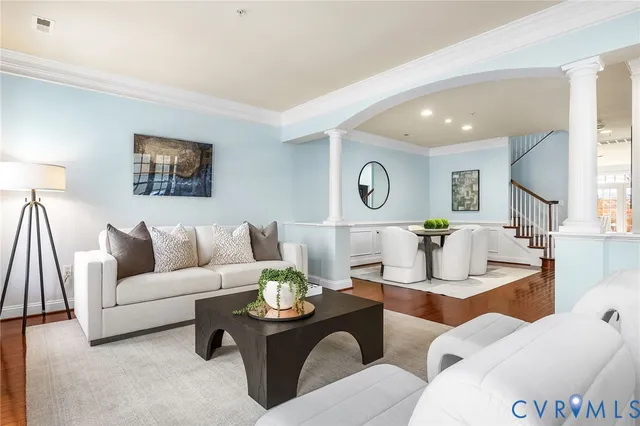 a view of a hallway with wooden floor and staircase