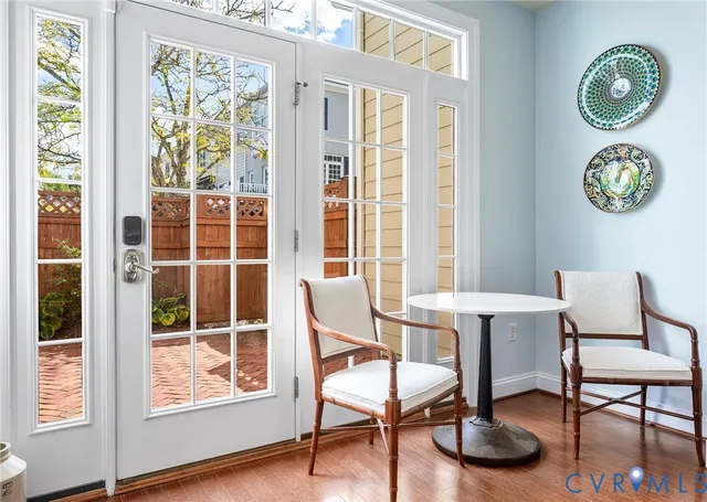 a living room with furniture and wooden floor