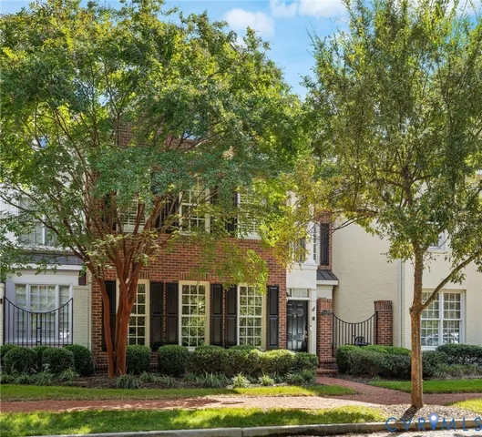 front view of a brick house next to a yard