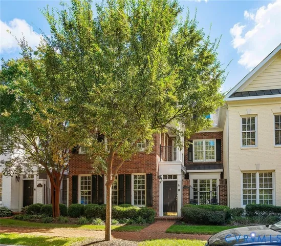 a view of a brick building next to a yard