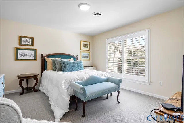 a view of a backyard with plants and a bench