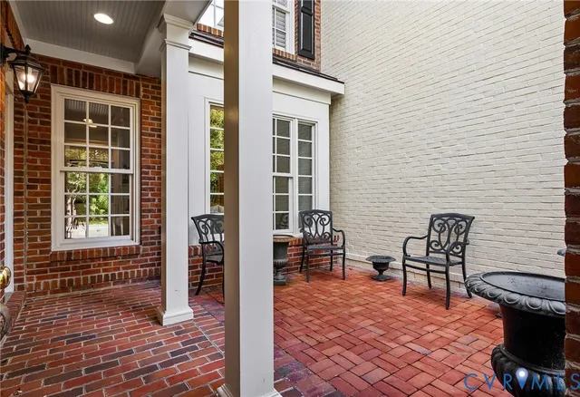 a view of a patio with table and chairs and wooden floor