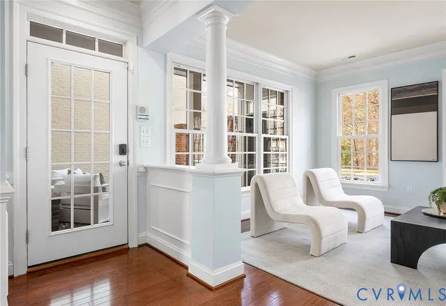 a kitchen with stainless steel appliances granite countertop a table chairs refrigerator and wooden cabinets