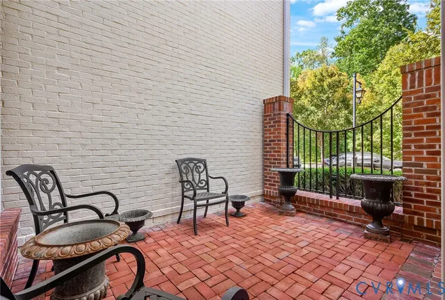 a balcony with chairs and a rug