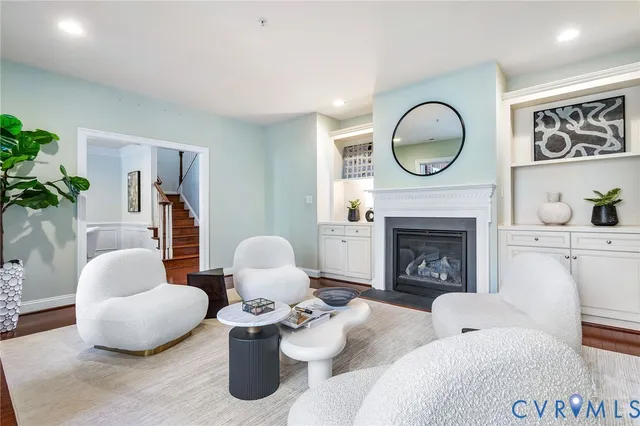 a kitchen with stainless steel appliances granite countertop a refrigerator a stove a sink a dining table and chairs