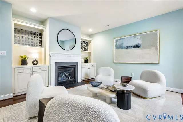 a kitchen with stainless steel appliances white cabinets a stove a sink and a refrigerator