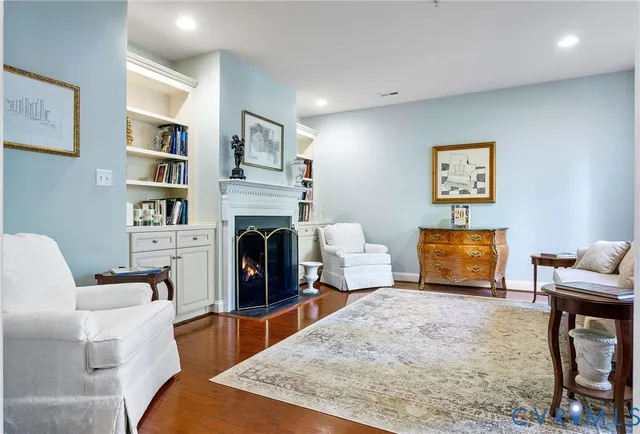 a living room with furniture a rug and a flat screen tv