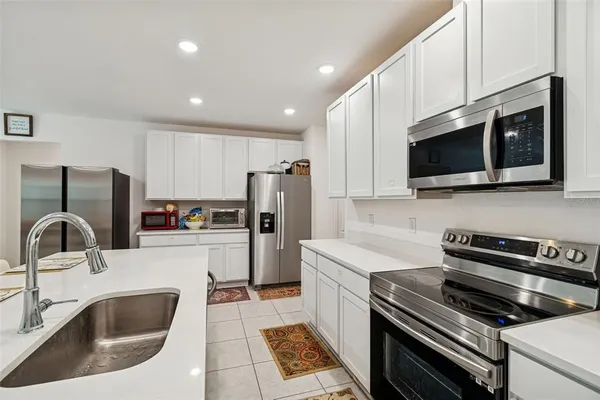 a kitchen that has a sink and a stove top oven