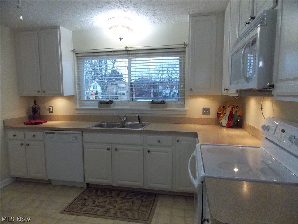 6299 South Canterbury Road Parma, OH 44129 - Photo 8 of 26 Updated white cabinetry, built in lazy susan and pantry. You will love cooking in this kitchen.
