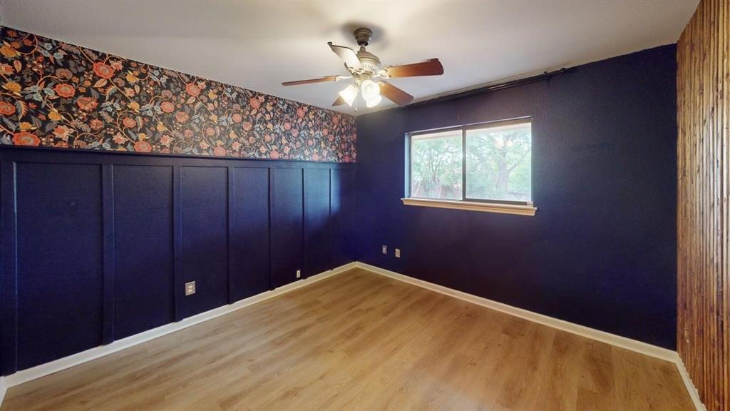 1535 Raleigh Drive Carrollton, TX 75007 - Photo 14 of 24 Interior room featuring wood-finish flooring, a ceiling fan with light fixture, and a window with a wood-finish sill