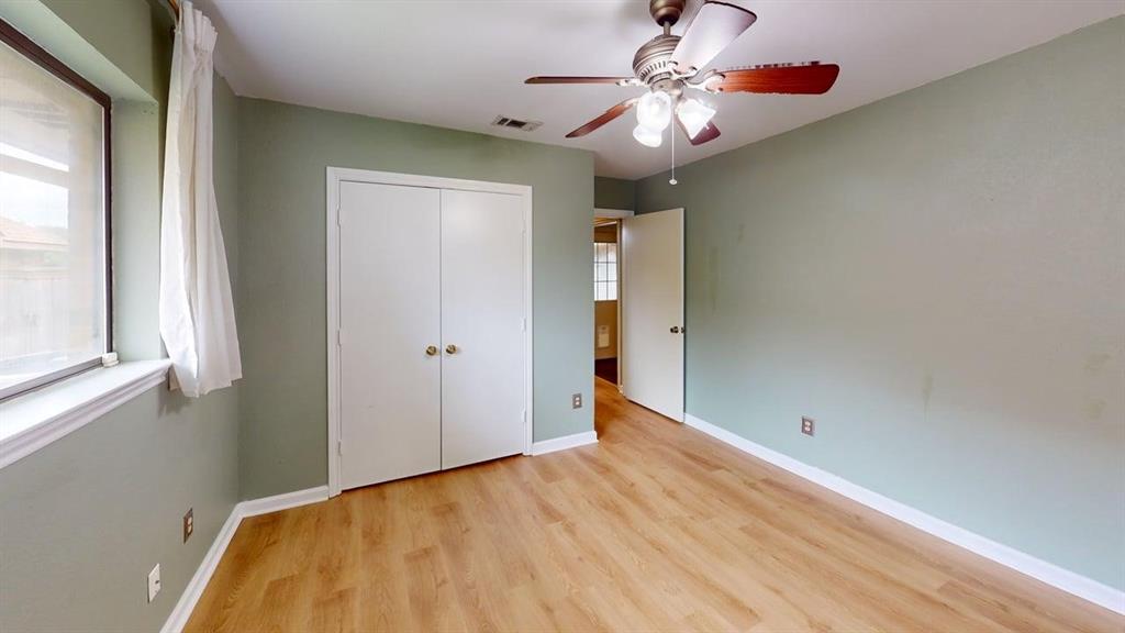 1535 Raleigh Drive Carrollton, TX 75007 - Photo 17 of 24 Room with wood-finish flooring, light green walls, and white baseboards