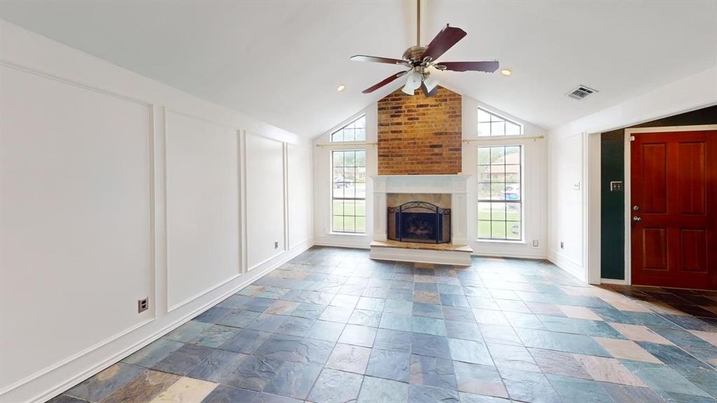 1535 Raleigh Drive Carrollton, TX 75007 - Photo 10 of 24 Spacious living area featuring a vaulted ceiling and a ceiling fan