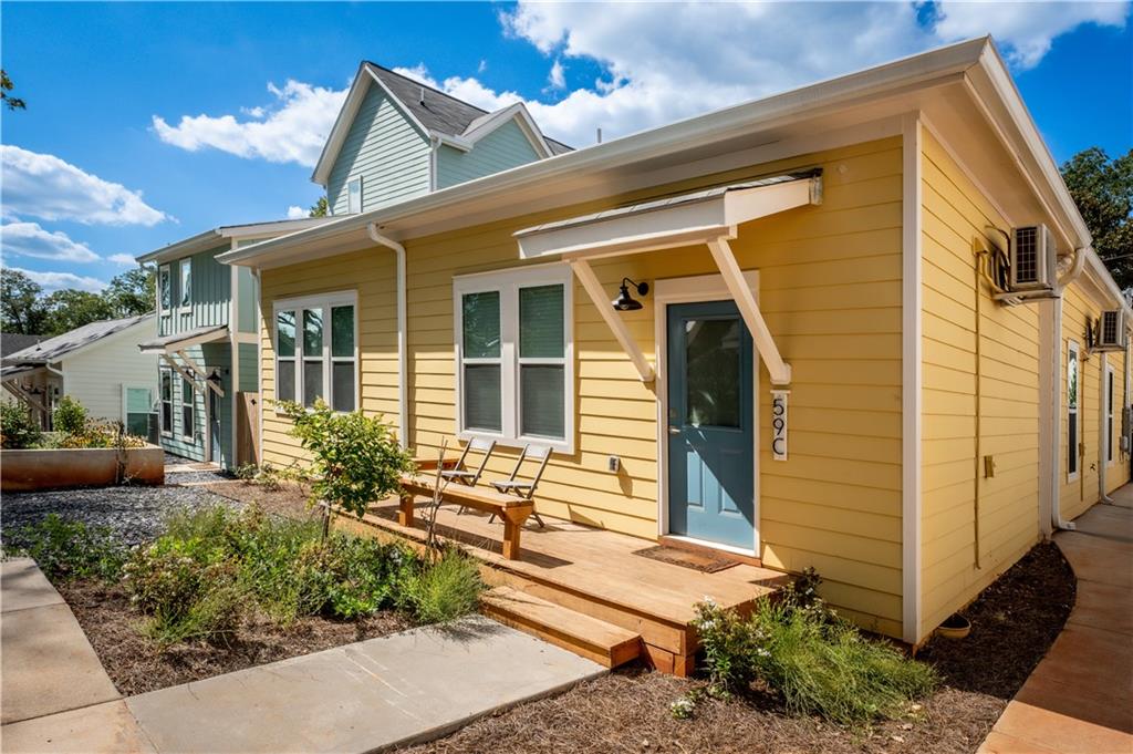 1359 Finley Street Northeast, Unit C Atlanta, GA 30307 - Photo 1 of 19 a front view of a house with garden