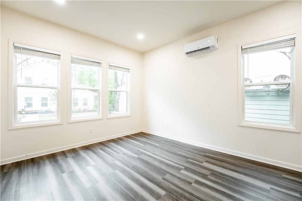 1359 Finley Street Northeast, Unit C Atlanta, GA 30307 - Photo 11 of 19 a view of an empty room with wooden floor and a window