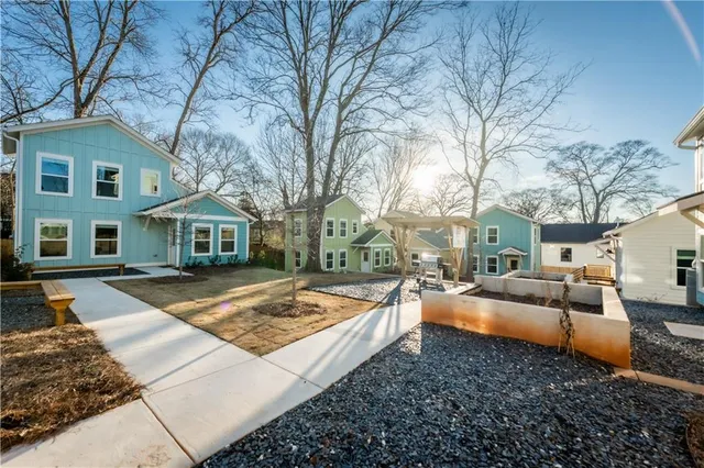 a view of a house with a yard covered with snow in the background