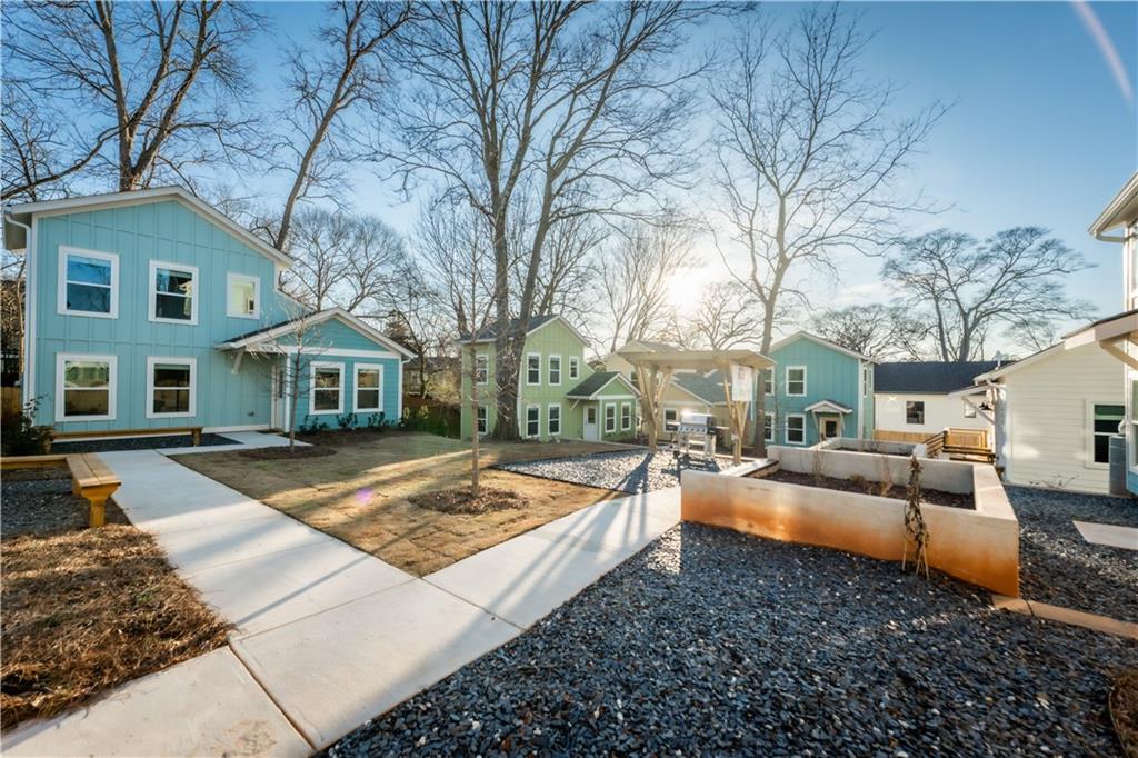 1359 Finley Street Northeast, Unit C Atlanta, GA 30307 - Photo 13 of 19 a view of a house with a yard covered with snow in the background